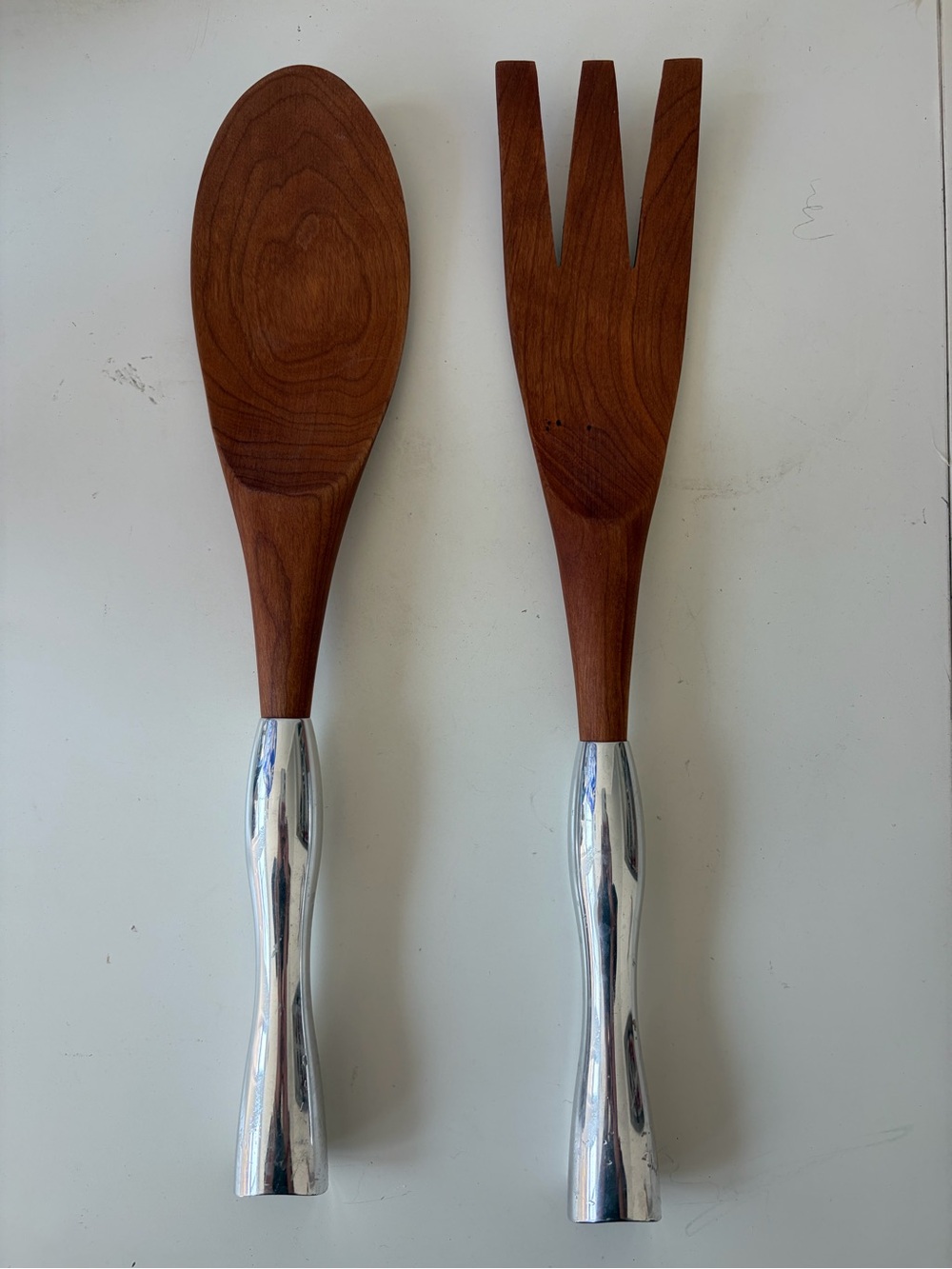 Pair of Nambé Studio cherry wood salad servers with silver-tone metal handles